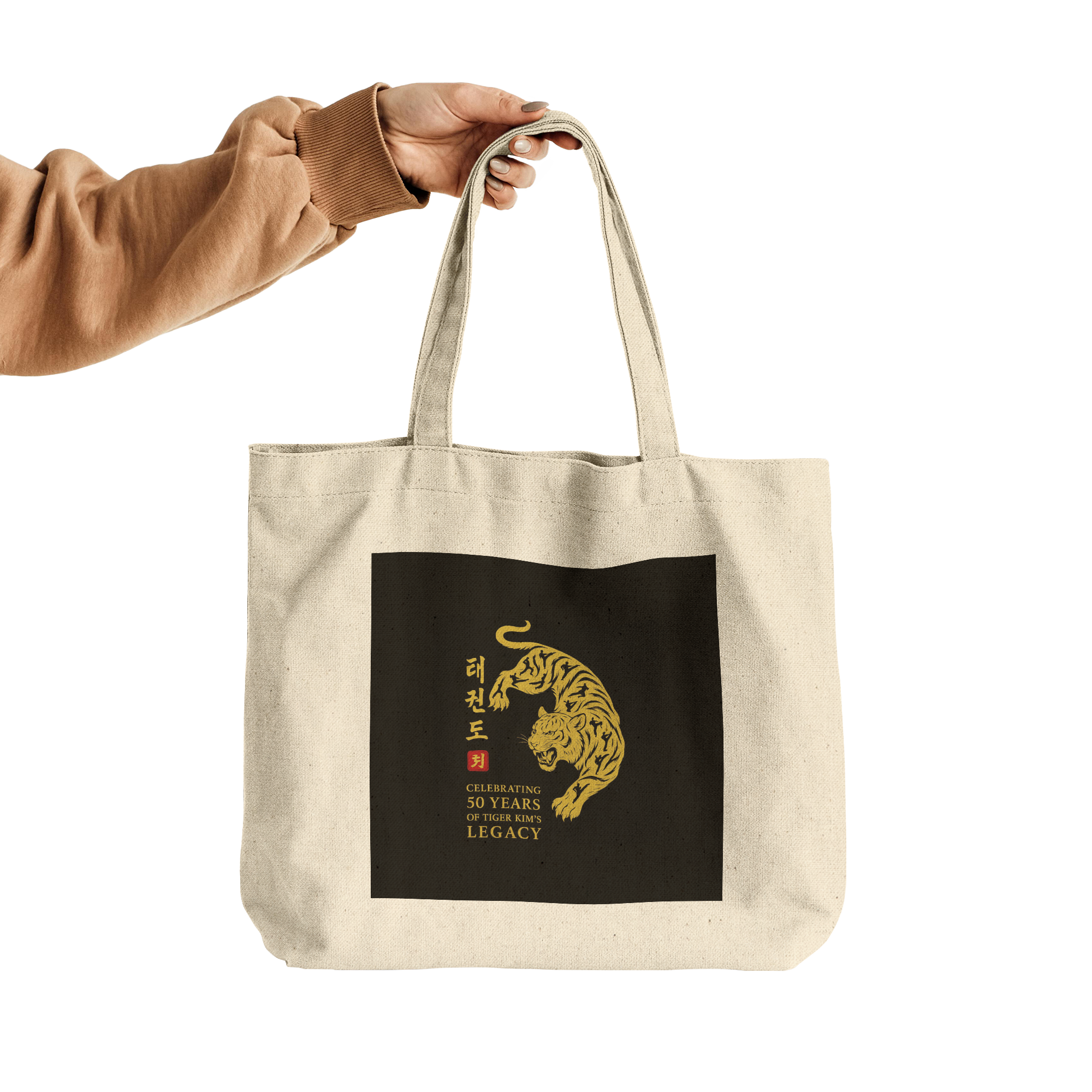 Tiger_Kims_Academy_50th_Anniversary_Leg_CottonTote_L_HandTransparent_Mockup.png