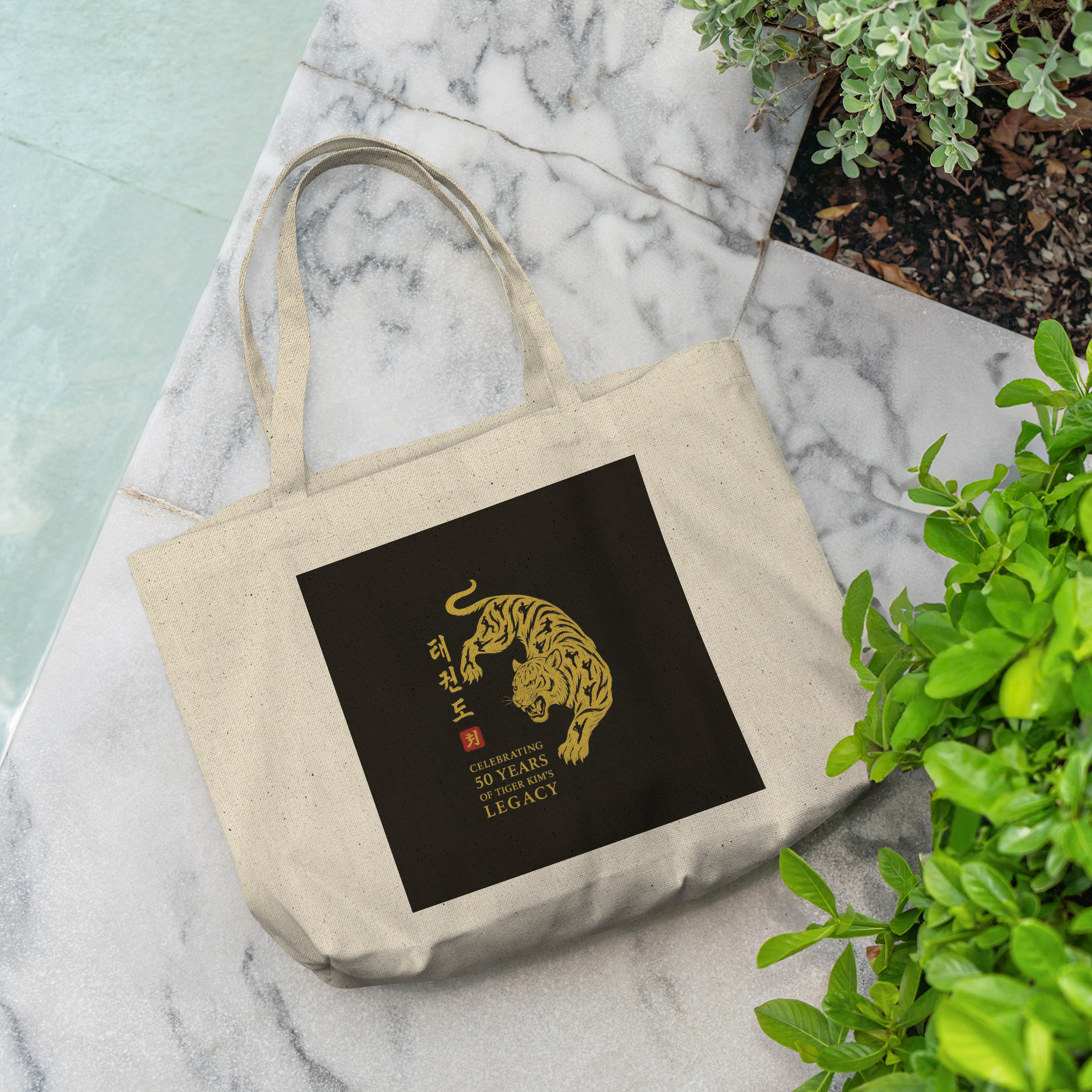 Tiger_Kims_Academy_50th_Anniversary_Leg_CottonTote_L_Pool_Mockup.png